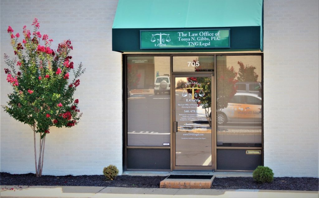 A business office with flowers outside of it.