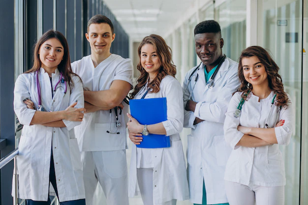 A group of doctors standing in a hallway.